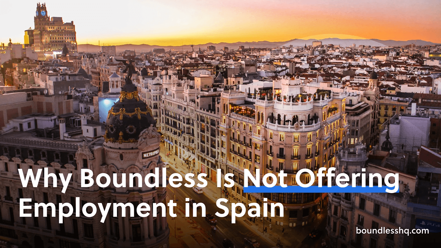 Aerial view of Madrid at dusk with prominent buildings illuminated, with overlaid text 'Why Boundless is Not Offering Employment in Spain' and the Boundless logo